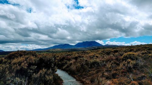 Scenic view of mountains against cloudy sky