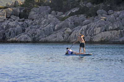 Full length of man on rock against sea