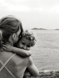 High angle view of young woman looking at sea against sky