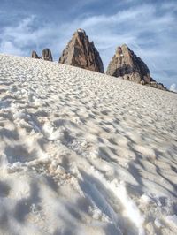 Low angle view of rocks on shore against sky