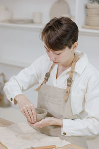 Side view of young woman working at home