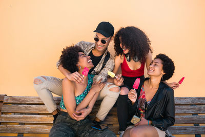 Young friends sitting outdoors