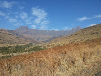 Scenic view of mountains against cloudy sky