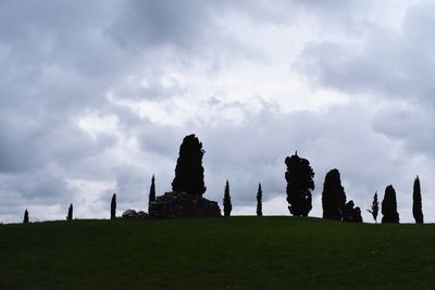 Built structure on field against cloudy sky