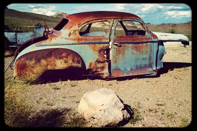 Abandoned car on field