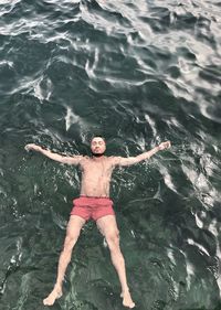 High angle view of man swimming in sea