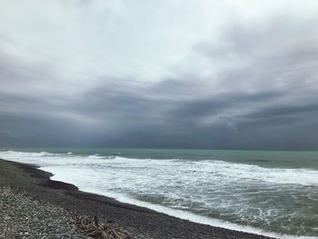 Scenic view of sea against storm clouds