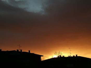 Low angle view of silhouette buildings against sky during sunset