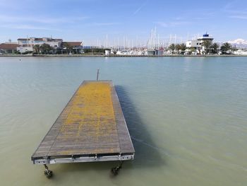High angle view of yellow floating platform on sea against sky
