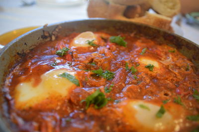 High angle view of fresh shakshouka served in plate on table