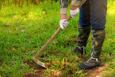 Low section of man standing on grass