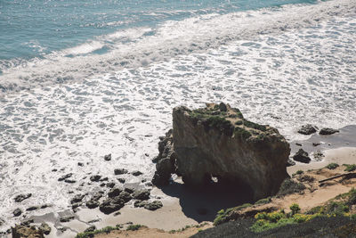 High angle view of rocks on beach against sky