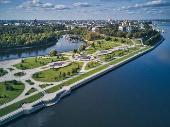 High angle view of swimming pool by river against sky