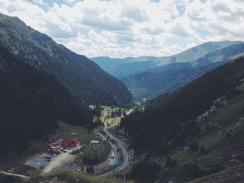 Scenic view of mountains against cloudy sky