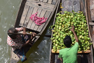 High angle view of people sells fruit in water