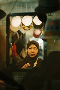 Portrait of woman wearing hat in restaurant