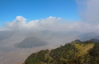 Scenic view of mountain range against blue sky