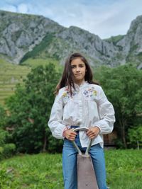 Portrait of smiling woman standing on mountain