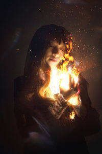Young woman with fire crackers at night