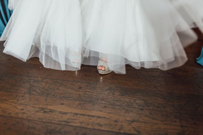 Low section of person on hardwood floor