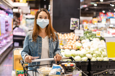 Full length of woman standing at market stall