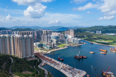 High angle view of bay and buildings against sky