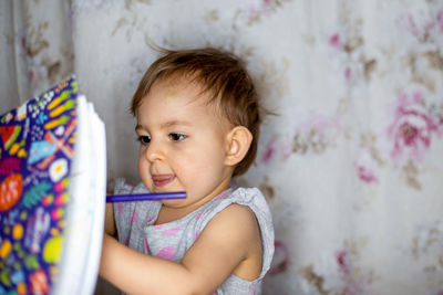 Portrait of cute baby girl at home