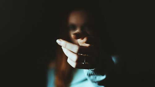 Close-up of young woman in darkroom