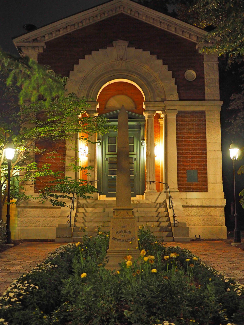 ILLUMINATED ENTRANCE OF BUILDING AT NIGHT