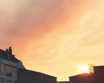 High section of building against sky at sunset