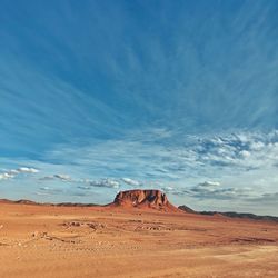 View of desert against cloudy sky