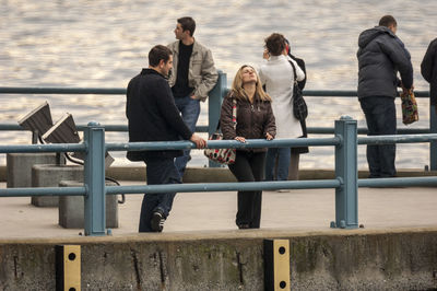 People sitting on railing