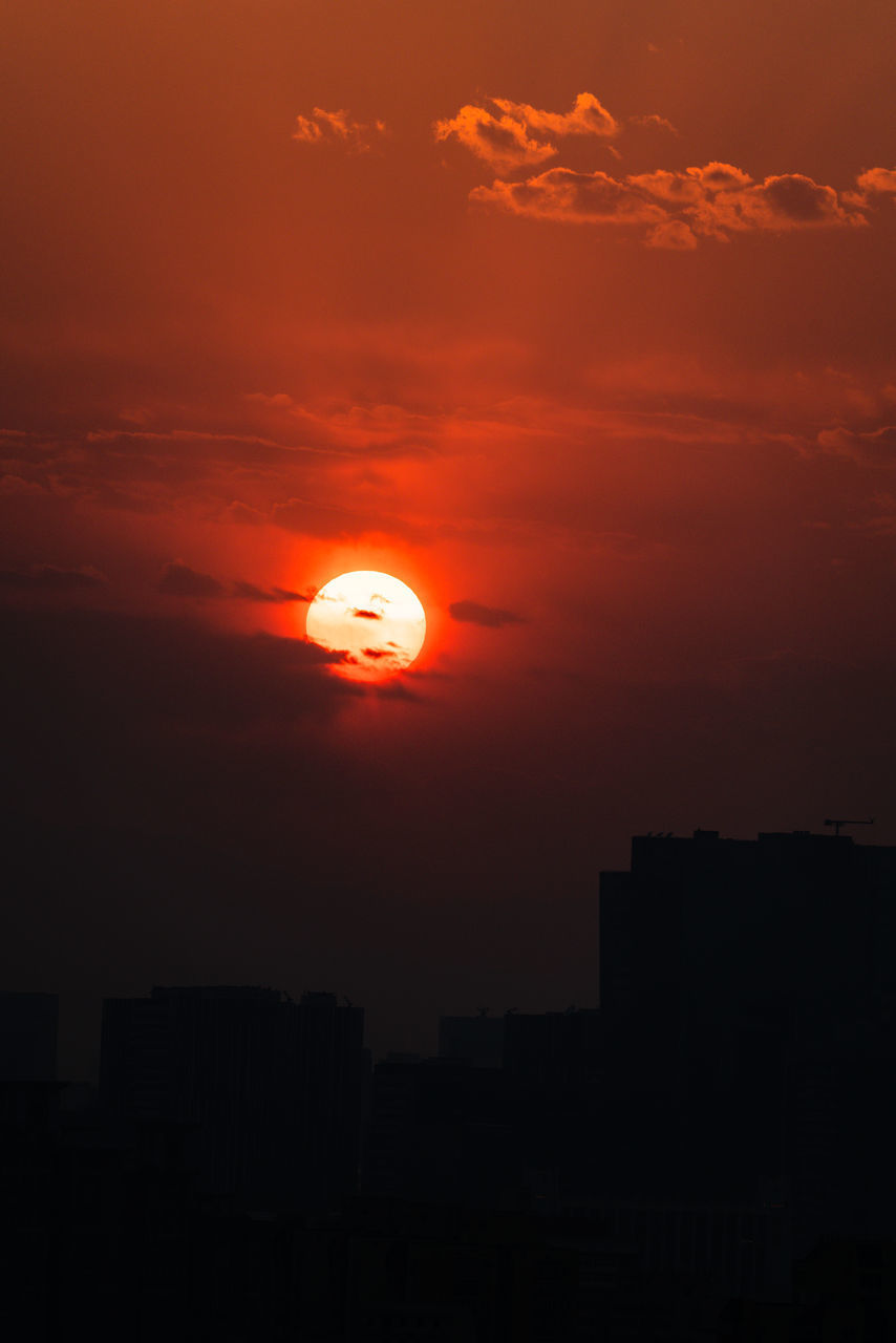 SILHOUETTE BUILDINGS AGAINST ORANGE SKY