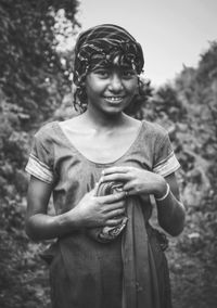 Portrait of smiling girl standing on field