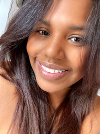 Close-up portrait of a smiling young woman