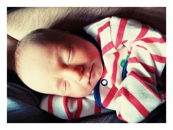 Close-up of baby boy sleeping on bed