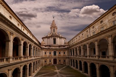 Low angle view of building against cloudy sky