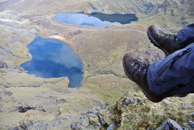 Low section of man dangling over landscape