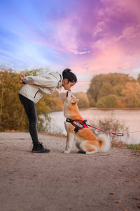 Man with dog against sky