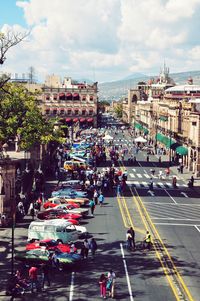 People on city street against sky