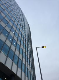 Low angle view of illuminated street light against sky