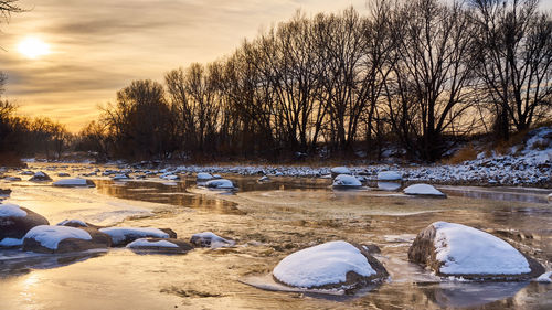 Scenic view of lake against sky during winter