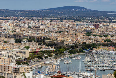 High angle view of townscape by sea against sky