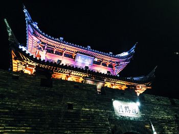 Low angle view of illuminated building at night