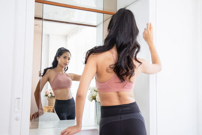 Young woman standing at home