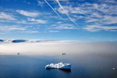 Sailboat in sea against sky