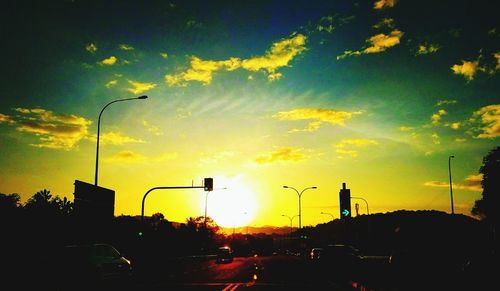 Traffic on road at sunset