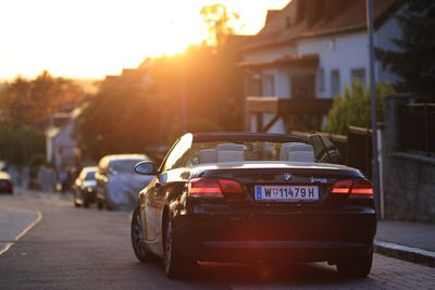 Car on street at sunset