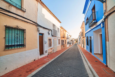 Empty alley amidst buildings in city