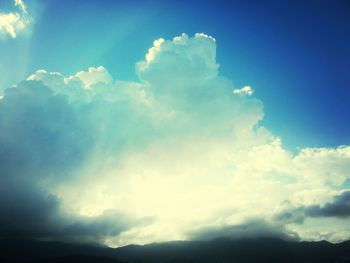 Scenic view of mountains against cloudy sky